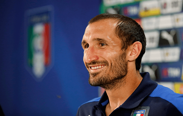 Smiling Giorgio Chiellini while wearing a shirt