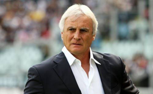 Palermo's new coach Giuseppe Papadopulo wears a soccer scarf during his  presentation in the Palermo soccer team headquarters Monday, Jan. 30, 2006.  Papadopulo was hired to replace Luigi Del Neri as coach