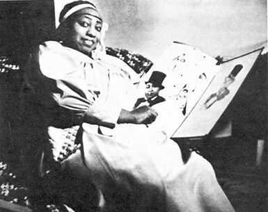 Gladys Bentley is smiling, sitting with a book on her left hand, and flipping its page using right hand, has black hair, wearing a white headband, and a white dress.