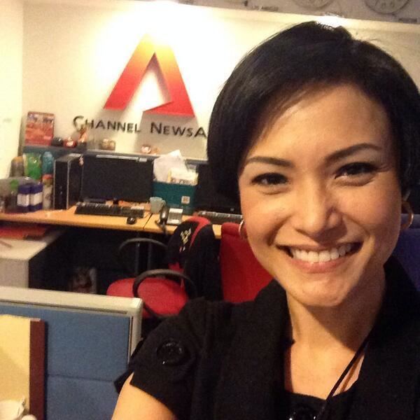 Glenda Chong smiling and wearing black blouse at Channel NewsAsia