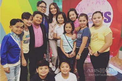 Casts of Goin' Bulilit with their Director wearing eyeglasses.