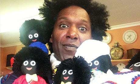 British author and broadcaster Lemn Sissay posing along with a bunch of Golliwog dolls inside his home.