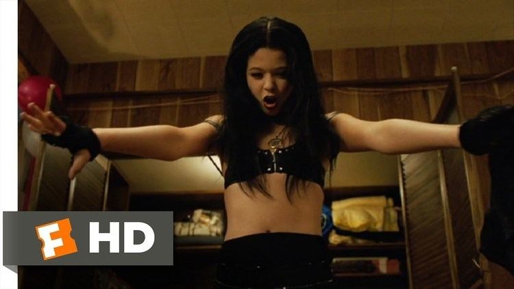 Sasha Pieterse with her arms open while wearing a black brassiere and gloves in a scene from the 2007 American comedy film, Good Luck Chuck