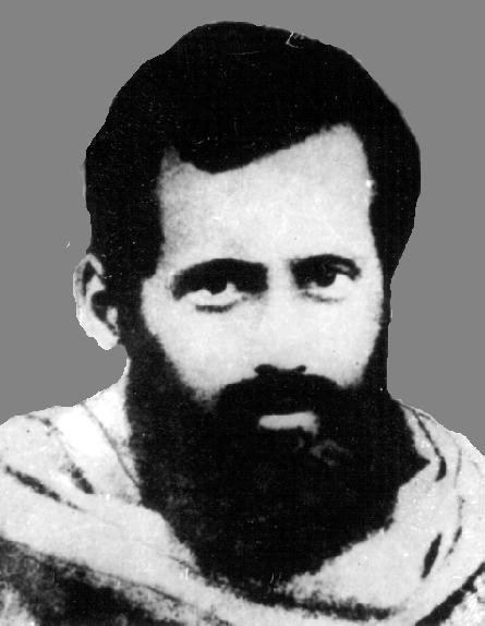 Gopabandhu Das smiling and with a thick beard and mustache.