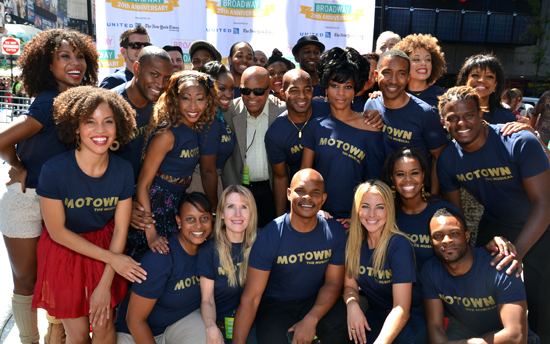 The entire Gordy family posing together with most of them wearing blue Motown shirts.