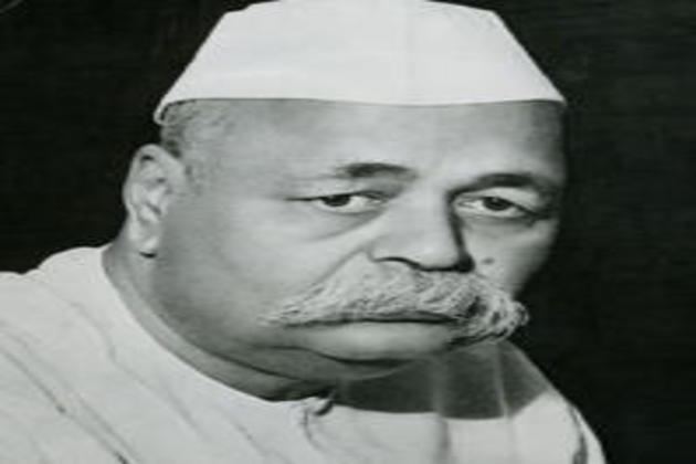 Govind Ballabh Pant posing with facial hair and wearing a white cap and clothes.