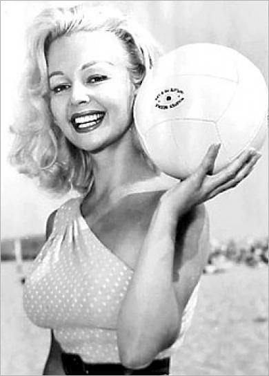 Greta Thyssen's gorgeous smile while holding the ball and wearing polka dot top