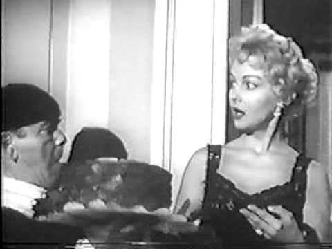 Greta Thyssen's shocked face while looking at the waiter holding a cake