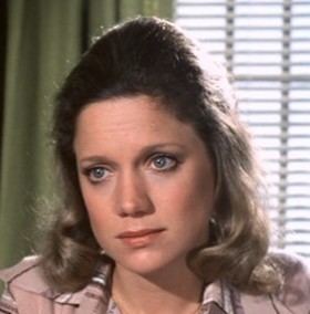 Gretchen Corbett in a fierce look wearing a sleeve