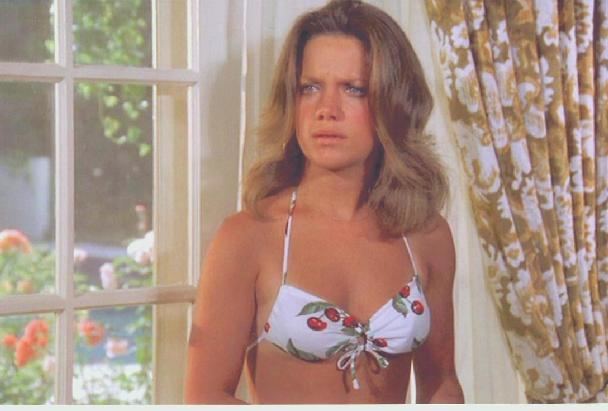 Gretchen Corbett in fierce look while wearing a swimsuit.