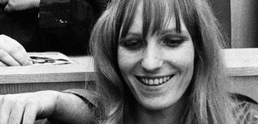 Gudrun Ensslin smiling with blonde hair and bangs.