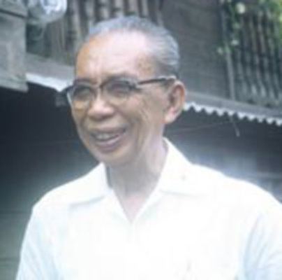 Guillermo Tolentino smiling while wearing white long sleeves and eyeglasses