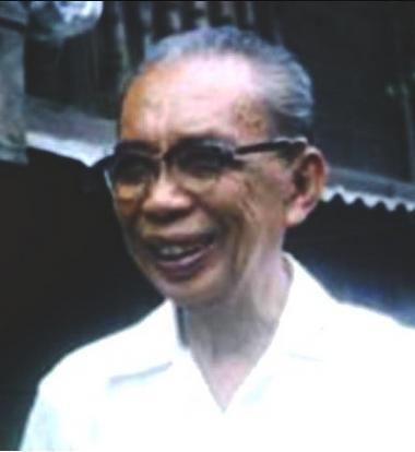 Guillermo Tolentino smiling while wearing white long sleeves and eyeglasses