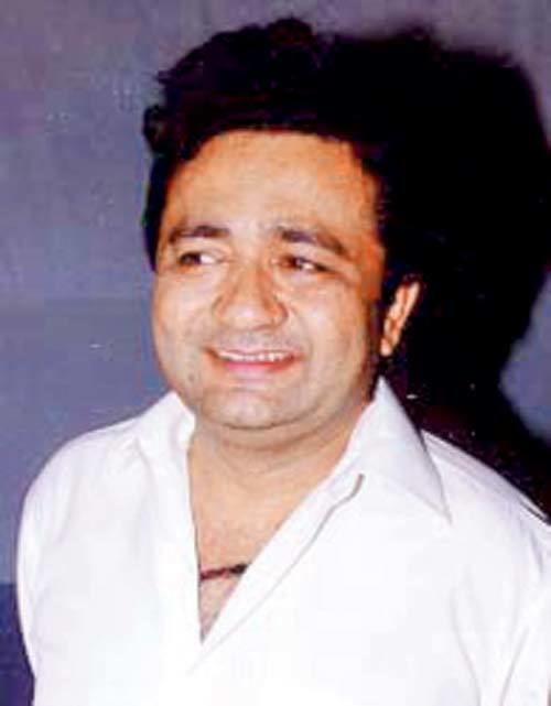 Gulshan Kumar smiling and wearing a white polo shirt.