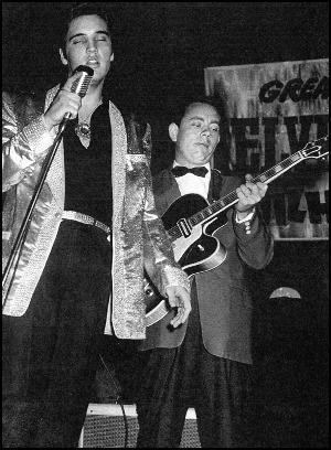 Hank Garland playing a guitar for a song performance of Elvis Presley.