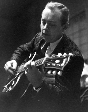 Hank Garland playing a guitar during a performance.