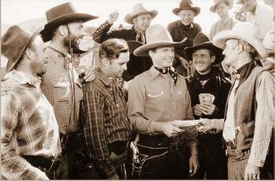 Bob Baker, Ken Card, Curley Gibson, Herman Hack, Chick Hannan, Art Mix, Lew Morphy, Wally West, and Hank Worden in a movie scene from "The Singing Outlaw" (1937 film)