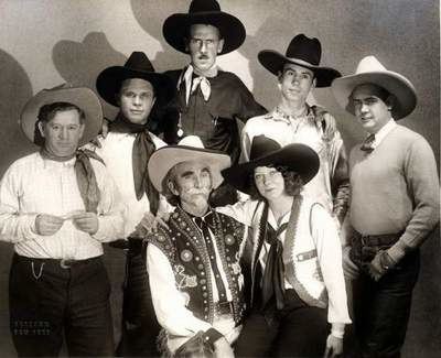 Hank Worden and the people beside him wearing a cowboy outfit