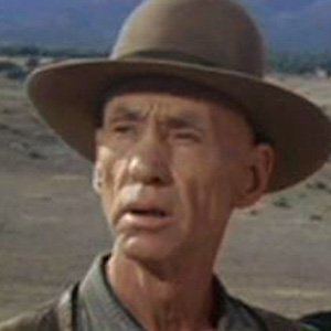 Hank Worden looking afar while wearing a hat