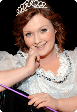 Hannah Hobley smiling while wearing a crown and white dress