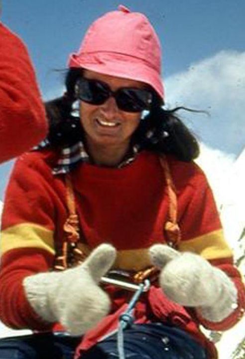 Hannelore Schmatz wearing a pink hat, sunglasses, gloves, and a red and yellow jacket.