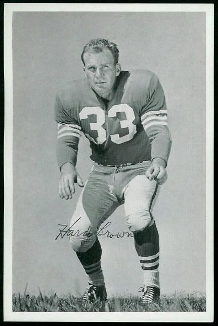 Hardy Brown on a defensive position and wearing a  football jersey numbered 33 and pants on a poster with his signature