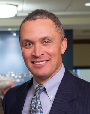 Harold Ford, Jr. with a smiling face and wearing a suit and a tie.