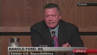 Harold Eugene Ford Sr. wearing a suit at a conference.