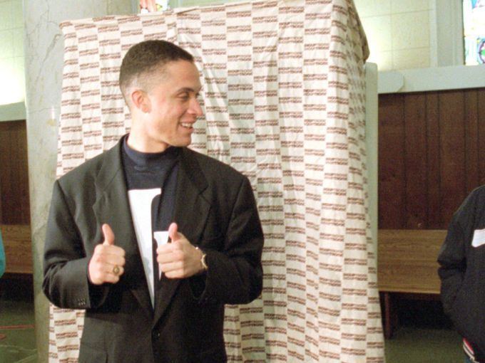 Harold Eugene Ford Jr., son of Harold Eugene Ford Sr. wearing a suit and doing thumbs up.