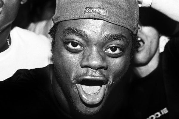 Harold Hunter with his mouth open while wearing a cap and black t-shirt