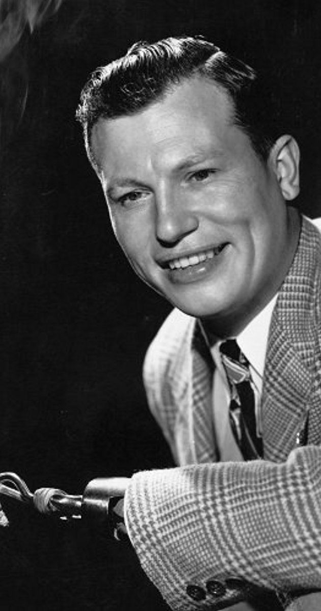 Close-up smile of Harold Russell wearing a suit in black and white