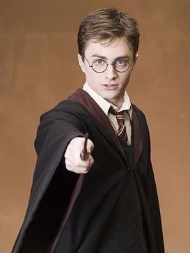 Daniel Radcliffe as Harry Potter with a serious face while holding a magic wand, wearing eyeglasses, a black coat over white long sleeves, and a striped necktie.