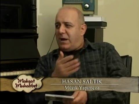 Hasan Saltık wearing a black checkered long sleeves in one of his interview