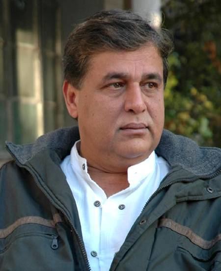 Hasnat Khan looking at the left side wearing a jacket
