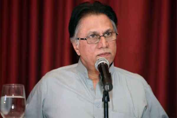 Hassan Nisar wearing eyeglasses and a polo shirt during an interview.