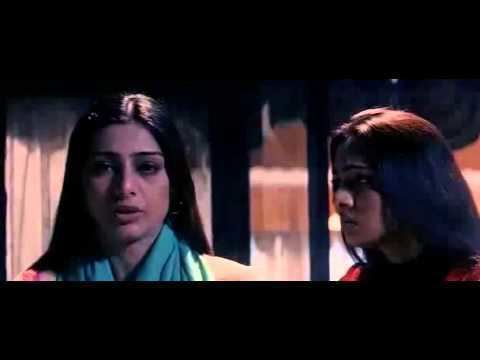 Tabu as Sanjana having a serious conversation with  Hansika Motwani as her daughter in a scene from the 2003 Hindi horror film, "Hawa". Sanjana has long, straight, black hair, wearing a blue-green scarf on her neck and a yellow top while Hansika is wearing a red top.