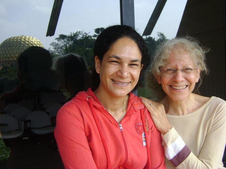 Heeba Shah standing and smiling together with an old woman beside her