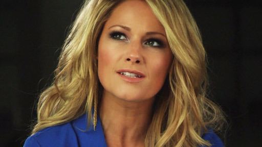 Helene Fischer looking at something while wearing a blue blouse