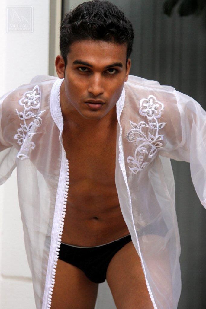 Hemal Ranasinghe wearing a white floral see-through jacket and black brief