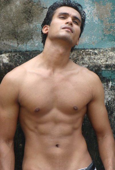 Hemal Ranasinghe showing his abs while his eyes are close