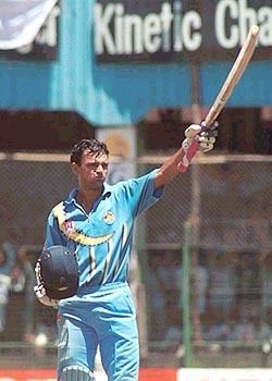 Hemang Badani raises his bat on reaching his hundred Photo