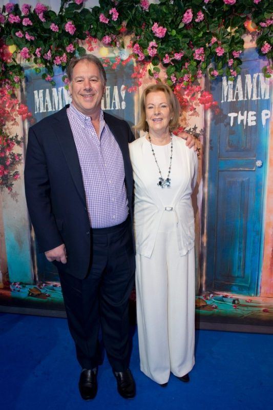 Henry Smith wearing black coat, white and blue long sleeves while Sara Suzanne Anlauf in her white outfit paired with necklace