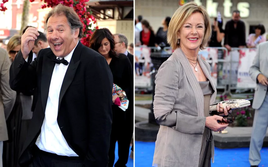 On the left Henry Smith wearing black coat, white long sleeves and bow tie while on the right side is Sara Suzanne Anlauf in her gray outfit while holding her shades and purse