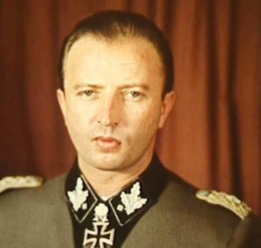 Hermann Fegelein wearing gray and black long sleeves with badge