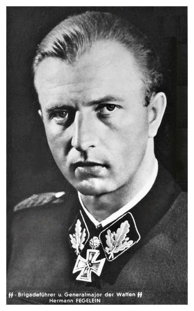 Hermann Fegelein's serious face while wearing gray and black long sleeves with a badge