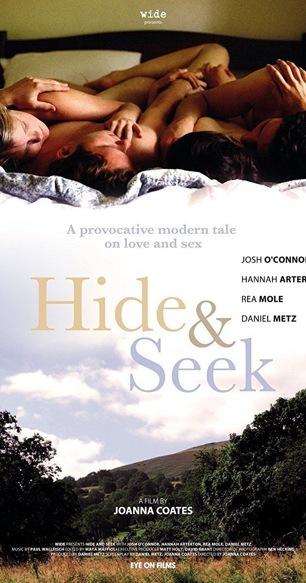 Josh O'Connor, Hannah Arterton, Rea Mole, and Daniel Metz lying on the bed in the theatrical release poster of the 2014 film, Hide and Seek