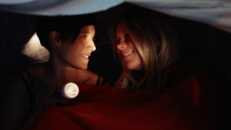 Hannah Arterton and Rea Mole smiling while staring at each other in a scene from the 2014 romantic drama film, Hide and Seek