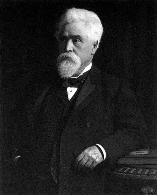 Hiram Maxim wearing a white shirt, a black suit, and a bow tie