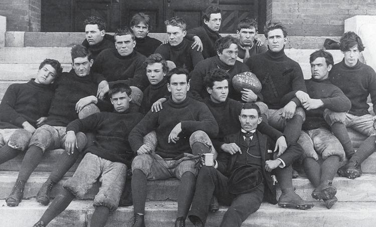Auburn Tigers football team in 1893 sitting on the stairs while wearing a turtleneck sweater, pants, high socks, and football boot