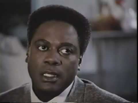 Howard Rollins wearing gray coat and white long sleeves